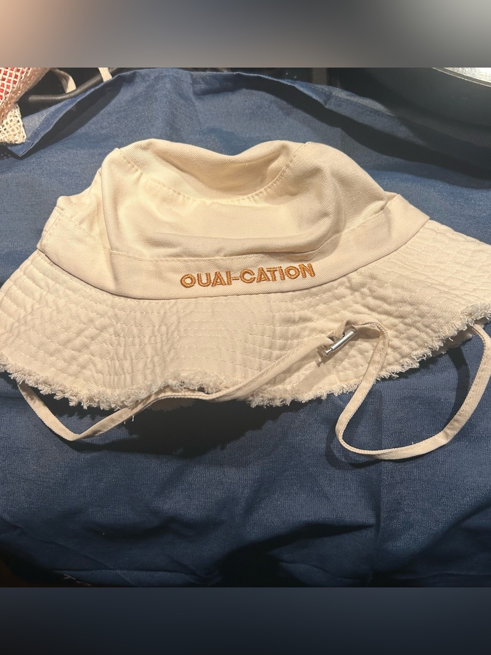 The Ouai “Ouai-cation” bucket hat with adjustable drawstring